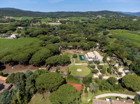 Photo for Aerial view on hills, houses and green vineyards Cotes de Provence, production of rose wine near Saint-Tropez and Pampelonne beach, Var, France in summer - Royalty Free Image