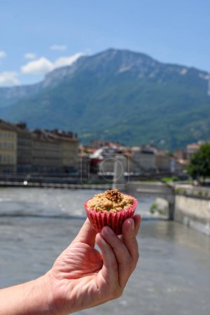 Photo for Gateau Grenoblois, French Walnut Coffee Cake, specialty from Grenoble and view on central part of Grenoble city witn mountains around, river Isere, France - Royalty Free Image