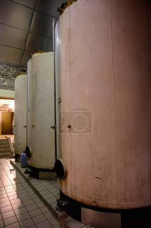 Photo for Concrete tanks for fermentation process. Visit of undergrounds caves, traditional producing of champagne wine in Cote des Bar, Aube, south of Champagne, France - Royalty Free Image