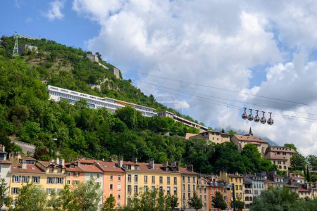 Photo for View from central part of Grenoble city to Bastille fortres witn mountains around, old cable car, Isere, France in summer - Royalty Free Image