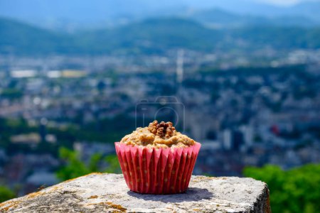 Photo for Gateau Grenoblois, French Walnut Coffee Cake, specialty from Grenoble and view on central part of Grenoble city from Bastille fortres witn mountains and old cable cars , Isere, France - Royalty Free Image