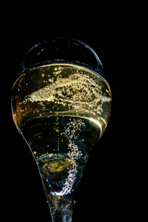 Photo for Glass of french sparkling champagne wine with bubbles on dark background, golden bubbles close up - Royalty Free Image
