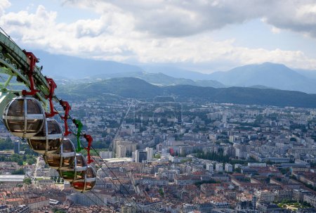 Photo for View on central part of Grenoble city from Bastille fortres witn mountains around, old cable car, Isere, France in summer - Royalty Free Image