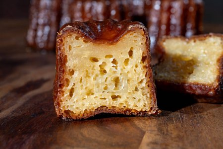 Canele, French pastry flavored with rum and vanilla, soft and tender custard center and  dark, caramelized crust specialty of Bordeaux region, France close up