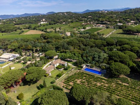 Photo for Aerial view on hills, houses and green vineyards Cotes de Provence, production of rose wine near Saint-Tropez and Pampelonne beach, Var, France in summer - Royalty Free Image