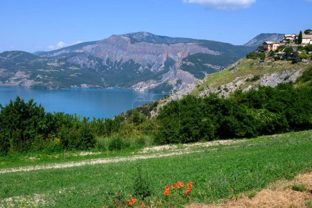 Photo for View on blue lake of Serre-Poncon, reservoir border between Hautes-Alpes and Alpes-de-Haute Provence   departments, one of largest in Western Europe - Royalty Free Image
