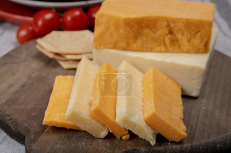 Photo for British cheeses collection, Scottish coloured and English matured cheddar cheeses close up - Royalty Free Image