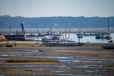 View on Arcachon Bay at low tide with many fisherman's boats and oysters farms from Cap Ferret peninsula, France, southwest of Bordeaux along France's Atlantic coastline