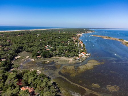 View on Arcachon Bay with many fisherman's boats and oysters farms near Le Phare du Cap Ferret and Duna du Pilat, Cap Ferret peninsula, France, southwest of Bordeaux, France's Atlantic coastline in sunny day
