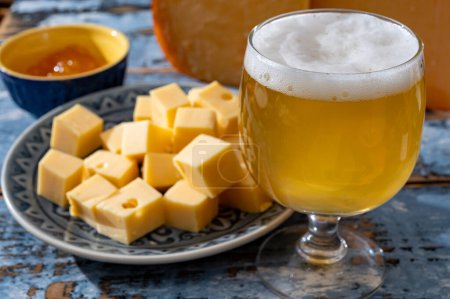 Cheese collection, Dutch ripe hard chees made from cow milk in the Netherlands in cubes and glass of white beer