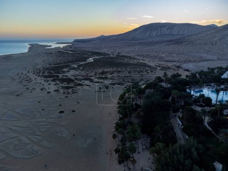 Aerial view on sandy dunes and turquoise water of Sotavento beach on sunset, Costa Calma, Fuerteventura, Canary islands, Spain in winter