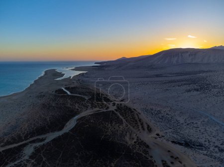 Aerial view on sandy dunes and turquoise water of Sotavento beach on sunset, Costa Calma, Fuerteventura, Canary islands, Spain in winter