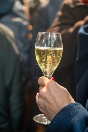 Visitors drinking of sparkling wine champagne on outdoor winter festival in December on Avenue de Champagne, Epernay, Champagne region, France