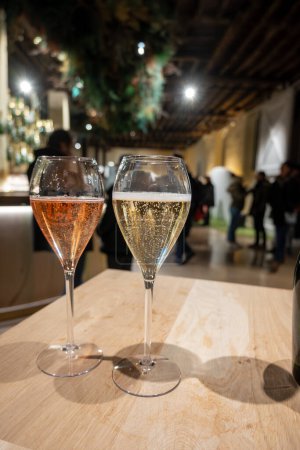 Glass with little bubbles, tasting of sparkling wine champagne on winter festival in December, Avenue de Champagne, Epernay, Champagne region, France