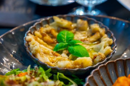 Photo for Vegetarian dishes, mezze in Turkish restaurant, bulgur pilaf, grilles eggplants and fresh green vegetables salad - Royalty Free Image