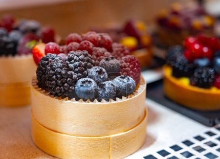 Italian sweet dessert dolce pastry and cakes with cream and fruits on display in artisanal bakery in Milan, Italy, close up