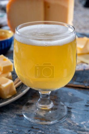 Cheese collection, Dutch ripe hard chees made from cow milk in the Netherlands in cubes and glass of white beer