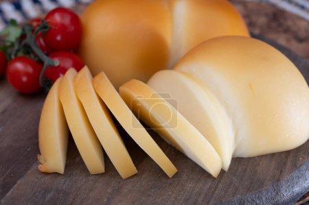 Cheese collection, Italian cheese scamorza, caciocavallo, provolone made from cow milk in South Italy yellow smoked cheese close up