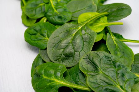 Fresh green baby Spinach leaves, diet and healthy food concept, weight loss, spinach background top view copy space