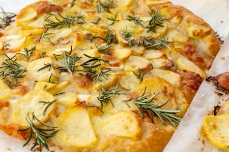 Fresh baked focaccia, pala romana pizza with potato vegetables and rosemary in bakery in Parma, Emilia Romania, Italy
