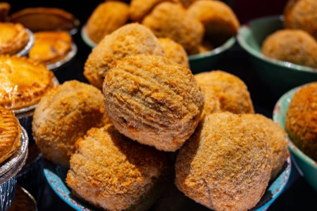 Traditional street food in UK, stuffed fried hot Scotch eggs with breadcrumbs close up
