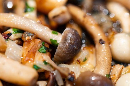 Roasted with onion white and brown shimeji edible mushrooms native to East Asia, buna-shimeji is widely cultivated and rich umami tasting compounds close up