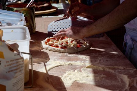 Making of fresh Italian pizza, street food court on  Portobello road food market on Saturday, London, UK