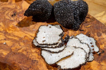 Slices of Italian black summer truffle, tasty aromatic mushroom, close up