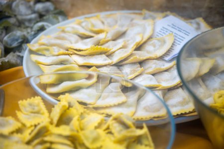 Italian food, fresh homemade stuffed pasta tortelli or ravioli dumplings ready to cook on display, Milan, Lombardy, Italy