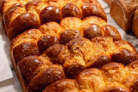 Traditional Jewish bread challah braided brioche bread in bakery close up