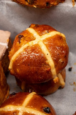 Traditional British Easter celebration food, fresh baked cross buns with raisins or apples
