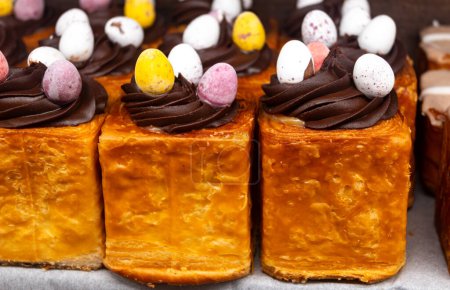 Traditional British Easter food, fresh baked stuffed buns with chocolate and decorative eggs in bakery