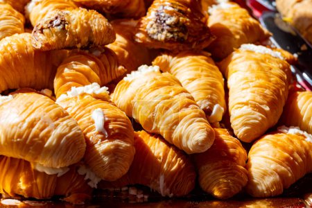 Naples sfogliatella, shell-shaped layered pastry, with sweet custard-like filling made with semolina, ricotta, and candied citrus fruit.  on market