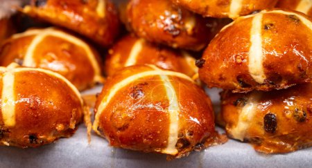 Traditional British Easter celebration food, fresh baked cross buns with raisins or apples