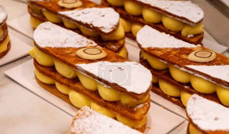 Portion of french mille-feuille cake, vanilla or custard slice, Napoleon puff pastry layered with pastry cream in bakery