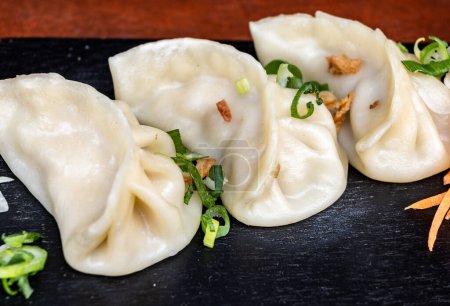 Asian food, steamed cooked filled gyoza dumplings ready to eat