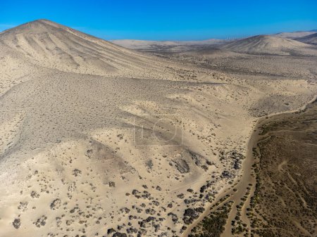 Sandy dunes and hills on Jandia peninsula near Playas de Sotavento en Costa Calma touristic resort, Fuerteventura, Canary islands, Spain in winter