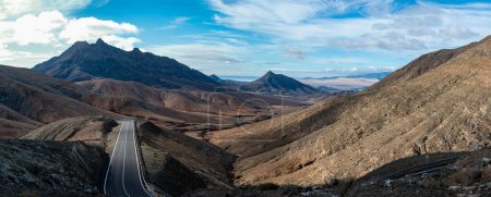 Photo for Panoramic view on colourful remote basal hills and mountains of Massif of Betancuria as seen from observation point, Fuerteventura, Canary islands, Spain, travel destination - Royalty Free Image