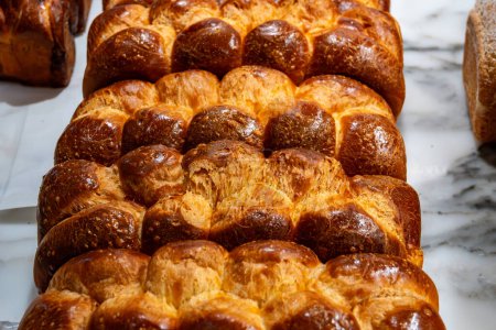 Traditional Jewish bread challah braided brioche bread in bakery close up