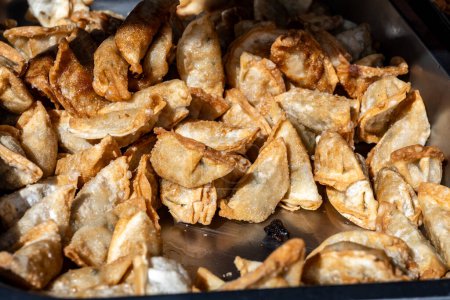 Asian food, fried in oil filled vegetarian dumplings on street market