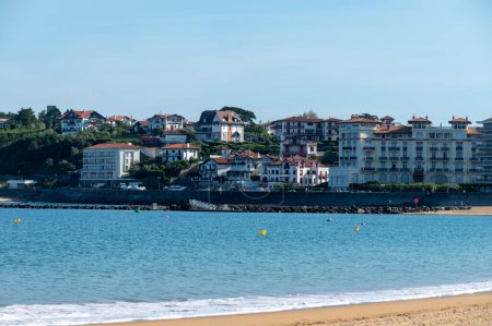 Sandy beach and houses of Saint Jean de Luz town on Basque coast, famous resort, known for beautiful architecture, nature and cuisine, South of France, Basque Country
