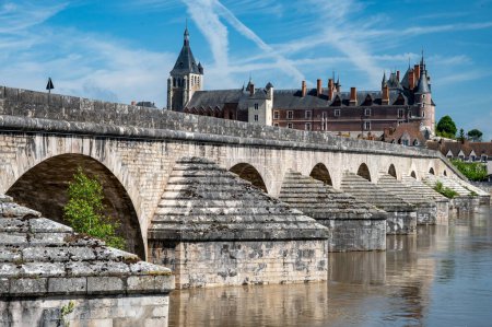 Views of old part of town of Gien on the Loire river, in Loiret department, France, houses with tiled roofs and chimneys, castle and bridge