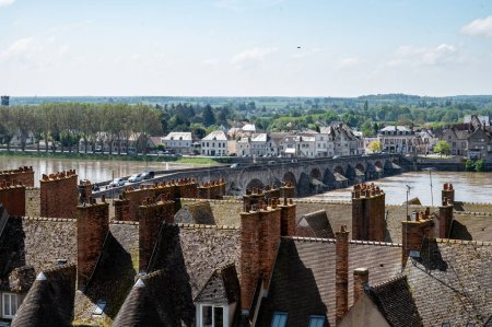 Views of old part of town of Gien on the Loire river, in Loiret department, France, houses with tiled roofs and chimneys, river and bridge
