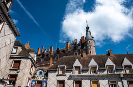 Views of old part of town of Gien on the Loire river, in Loiret department, France, houses with tiled roofs and chimneys, castle towers