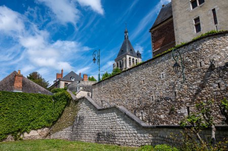 Views of old part of town of Gien on the Loire river, in Loiret department, France, houses with iled roofs and chimneys, river and bridge