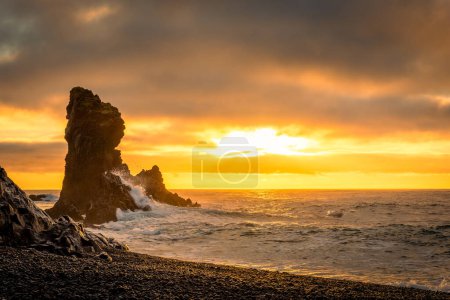 Sunset over the volcanic lava formations of Djupalonssandur beach, Iceland