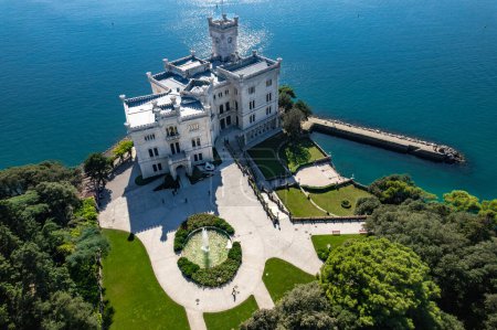 An aerial of the Miramare Castle in the scenic Gulf of Trieste in Italy captured on a bright day. High quality photo