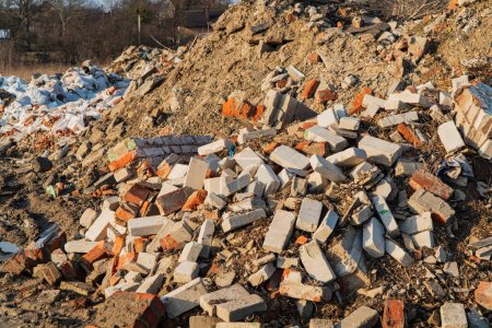 A pile of building bricks. Unused bricks after construction. Garbage remained after construction. Pile of concrete debris.