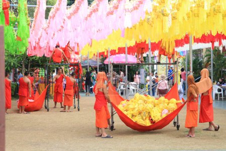 Foto de LÁNFUN-TAILANDIA: 11 de noviembre de 2023: monjes budistas y novicios budistas se preparan para el Festival de los Cien Mil Linternas, o Festival Yi Peng, en Wat Phra That Hariphunchai, norte de Tailandia - Imagen libre de derechos