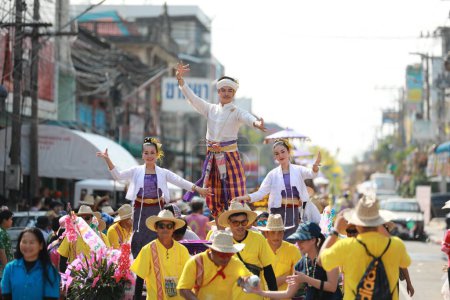 Photo for Lampang, Thailand, April 13, 2024: Performers with beautiful females and Hansom male actors in traditional costume in Lanna style take part in a Songkran parade to celebrate the Salung Luang Klong Yai Festival - Royalty Free Image